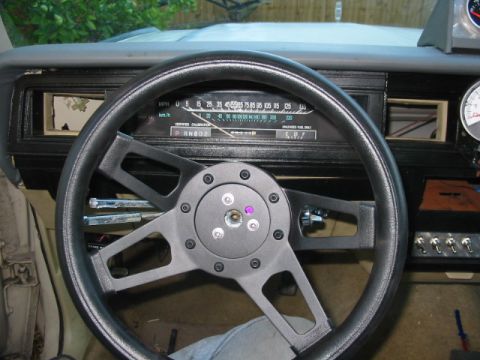 1985 Ford Crown Victoria LTD - Interior view of a car's dashboard with an aftermarket steering wheel and gauges.