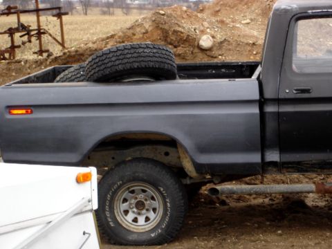 1979 Ford Bronco - This Ford pickup truck appears to be from the late 1970s, possibly a 1979 model, with a spare tire in the bed.