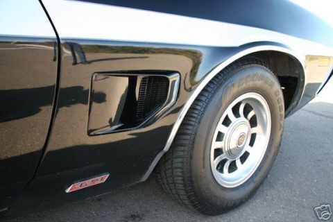 1970 Ford Ranchero - Close-up of the side of a black 1970 Ford Ranchero, highlighting its fender vent and wheel.