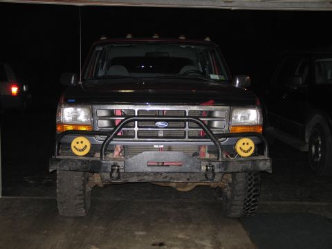 1995 Ford Bronco - Front view of a 1995 Ford Bronco a custom bumper and distinctive smiley face fog lights.