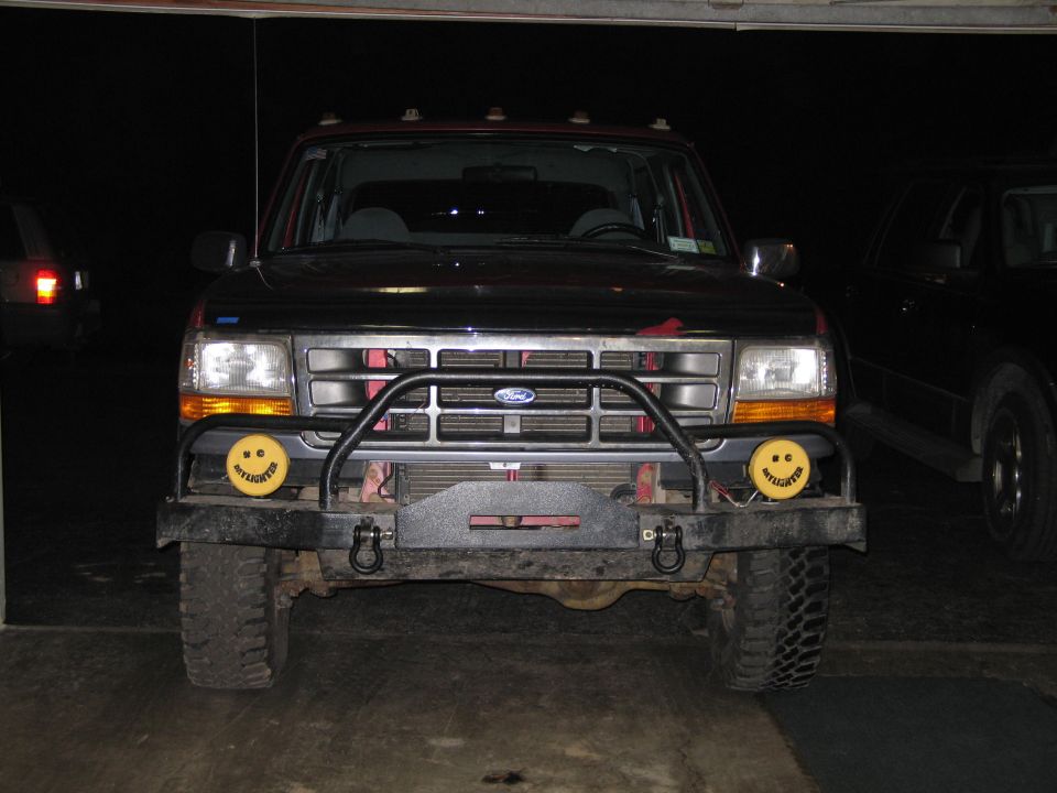 1995 Ford Bronco front bumper with tow hooks and yellow smiley face fog lights