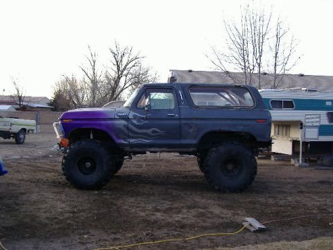 1979 Ford Bronco - This lifted 1979 Ford Bronco features a custom purple fender and flame graphics on its side.
