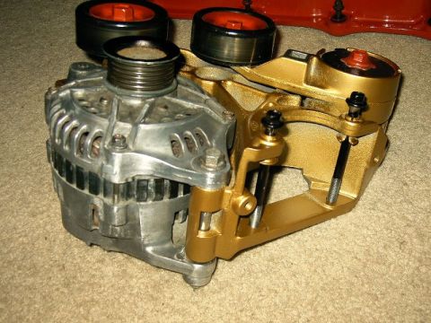 1992 Ford Probe - This is a close-up view of an automotive alternator, a custom gold-colored mounting bracket.