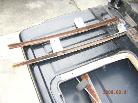 1986 Chevrolet Blazer - Close-up view of disassembled tailgate components, showing metal strips and brackets.
