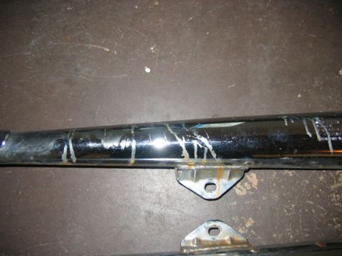 1985 Ford LTD Crown Victoria - Exhaust pipe section showing wear and tear, with visible rust and white residue.