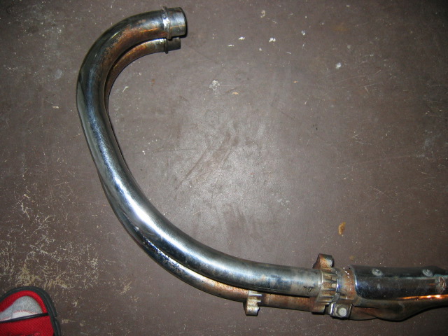 Chrome motorcycle exhaust pipe with two pipes merging