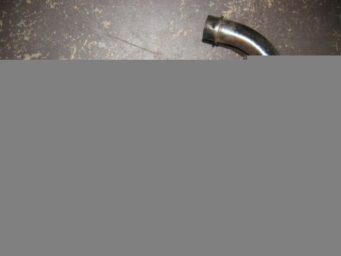 1985 Ford LTD Crown Victoria - A single exhaust pipe is shown against a dark, textured background.