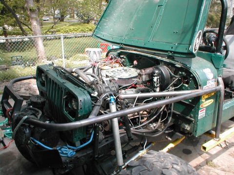 1983 Ford Bronco - Jeep engine bay with hood open, showing engine and custom modifications.