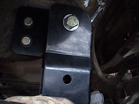 1994 Ford Bronco - Close-up of a suspension lift bracket, likely part of a Sky Shackle Flip Install, showing bolted components.