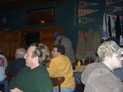 1996 Ford Bronco - A group of people are gathered inside a bar, with college pennants decorating the wall.