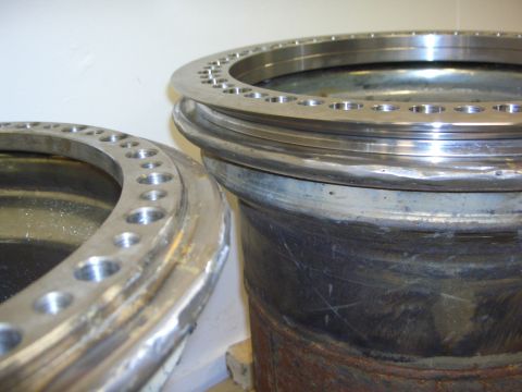 1996 Ford Bronco - Close-up of two large metal rings with numerous bolt holes, likely industrial parts.