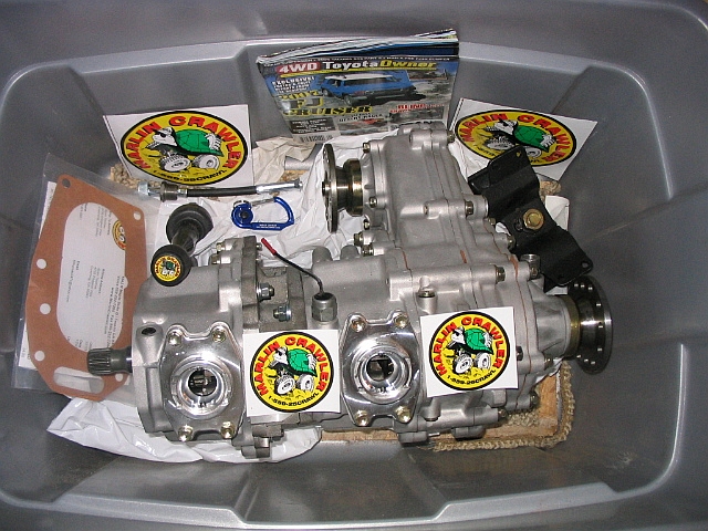 Toyota transfer case with Marlin Crawler stickers and a 4WD Toyota Owner magazine