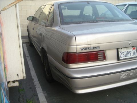 1991 Ford Taurus - Rear view of a silver 1991 Ford Taurus sedan with a California license plate.