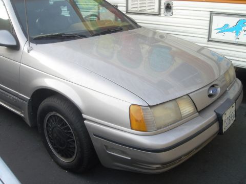 1991 Ford Taurus - This 1991 Ford Taurus is shown from the front, parked next to a trailer.