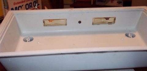 1985 Ford Crown Victoria LTD - This is a close-up of a white plastic interior car light housing with visible mounting points and openings.