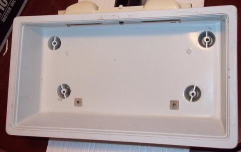 1985 Ford Crown Victoria LTD - A white plastic license plate frame is shown from the front, with a Supermotors watermark visible.