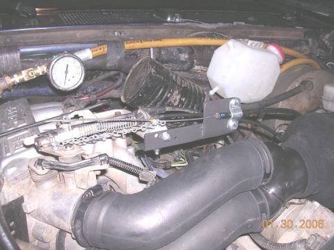 1994 Ford Bronco - the new throttle cable attached, allows for micro adjustment of the throttle and holds it there. Also has an emergency shut down.