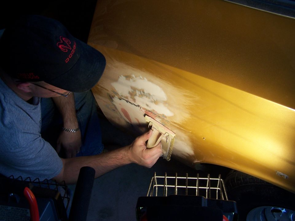 Hand sanding glazing putty over bondo.  Had to fill in some gaps with the mud.