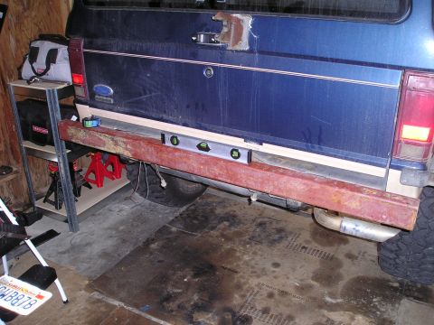 1986 Ford Bronco II - Installing a new rear bumper on a 1986 Ford Bronco II with tools and equipment.