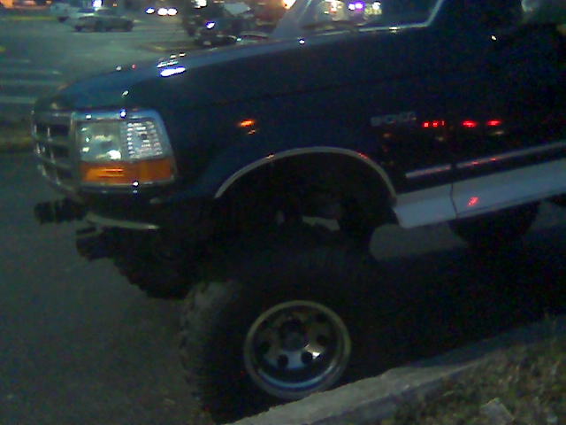 Dark 1992 Ford Bronco 3q front view with lifted suspension
