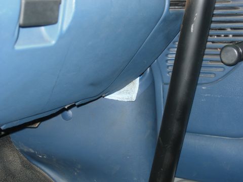 1995 Ford Bronco - Interior view of a vehicle's dashboard and floor, showing a roll bar and a golf ball.