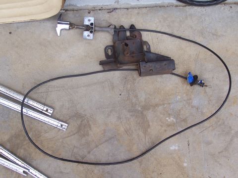 1978 Ford Bronco - Door latch mechanism and cable assembly shown on a concrete surface.