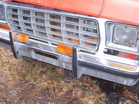 1978 Ford Bronco - Close-up of the front grille and chrome bumper of an older Ford pickup truck.
