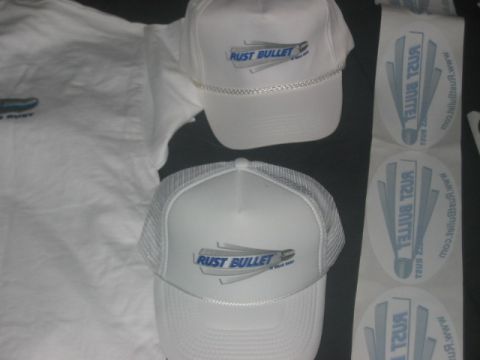 1991 Ford Bronco - Merchandise the RUST BULLET logo, including two hats and a t-shirt, alongside stickers.