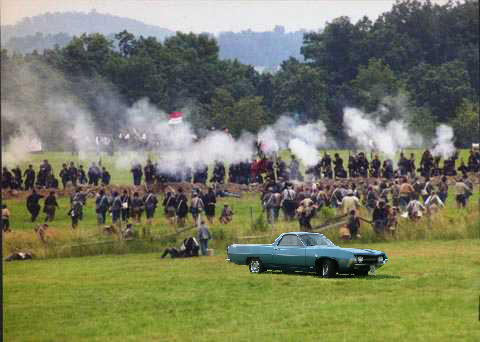 1979 Ford Ranchero - A teal 1979 Ford Ranchero is parked in a grassy field during a Civil War reenactment.