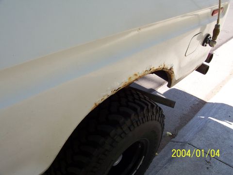 1978 Ford Bronco - Rust is visible on the rear wheel well of this white vehicle, dated 2004/01/04.