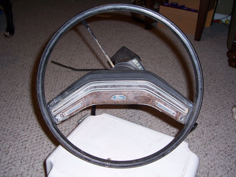 Ford steering wheel with wood grain trim and Ford logo