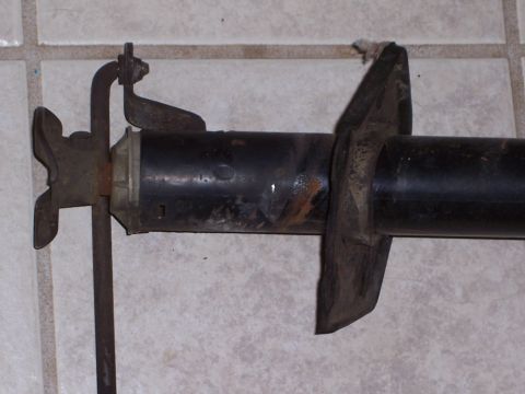 1978 Ford Bronco - Close-up of an automotive part with visible rust and metal components.