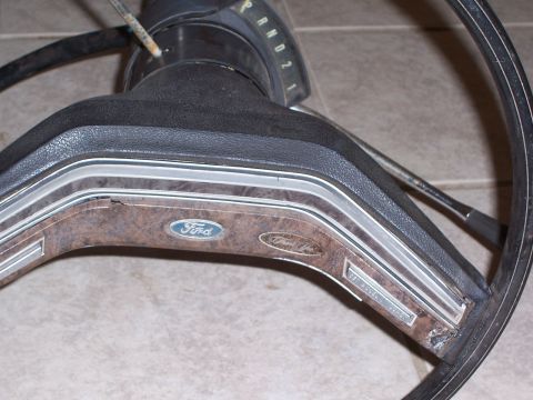 1978 Ford Bronco - Close-up of a 1978 Ford Bronco steering wheel, woodgrain trim and the iconic Ford emblem.