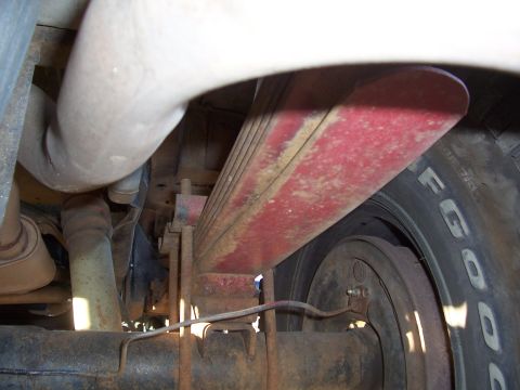 1978 Ford Bronco - This image shows the rear suspension components of a vehicle, including a leaf spring and tire.
