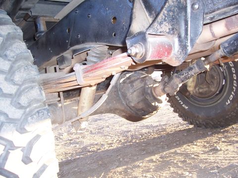 1978 Ford Bronco - Undercarriage view shows the rear axle assembly and suspension of a vehicle.