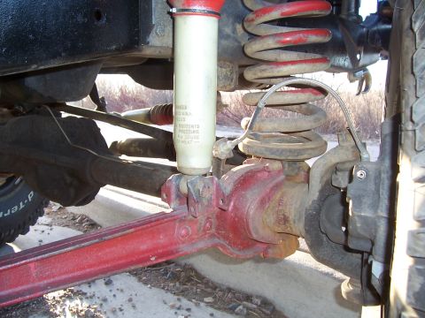 1978 Ford Bronco - This image shows the suspension lift components of a vehicle, including a shock absorber and coil spring.