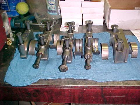 1967 Ford Galaxie - Engine connecting rod caps and bolts are arranged on a blue cloth on a workbench.