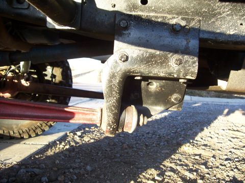 1978 Ford Bronco - A close-up view of a vehicle's suspension system, showing a bracket and linkage attached to the frame.