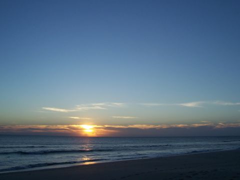 1994 Ford Probe - A beach scene captures the sun setting over the ocean, with a prominent SUPERMOTORS watermark in the lower right corner.