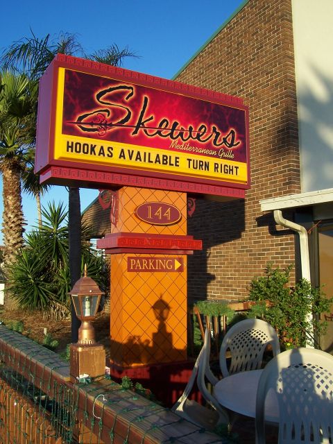 1994 Ford Probe - A sign for Skewers Mediterranean Grille indicates hookahs are available and directs customers to turn right.