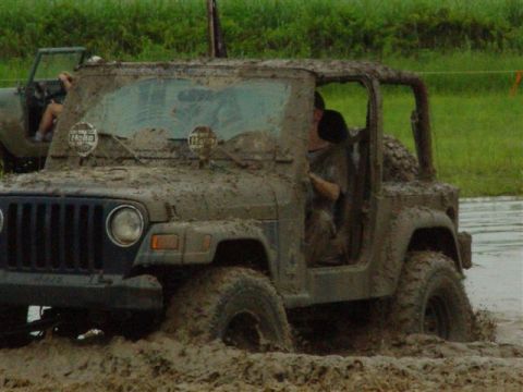 2002 Jeep Wrangler - Two Jeeps are stuck in the mud during an off-road event.