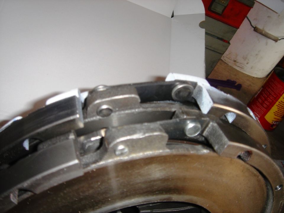 Clutch pressure plate with metal fingers and friction material