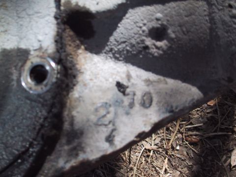 1990 Ford Bronco - A close-up view of a metal component shows stamped casting numbers, possibly indicating its manufacturing date.