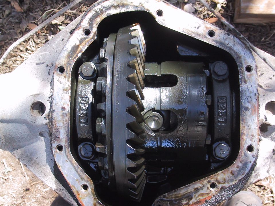 Differential housing with gears and bolts, showing internal components