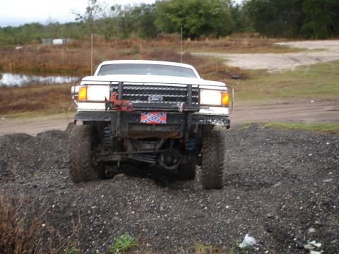 1989 Ford Bronco - This lifted 1987 Ford F-150 features aggressive off-road tires and a prominent confederate flag on its custom bumper.