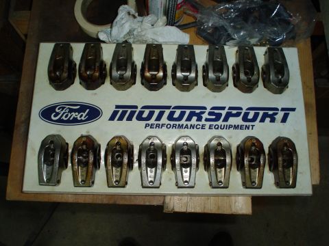 1984 Ford Bronco - A collection of Ford Motorsport rocker arms are laid out on a display board.