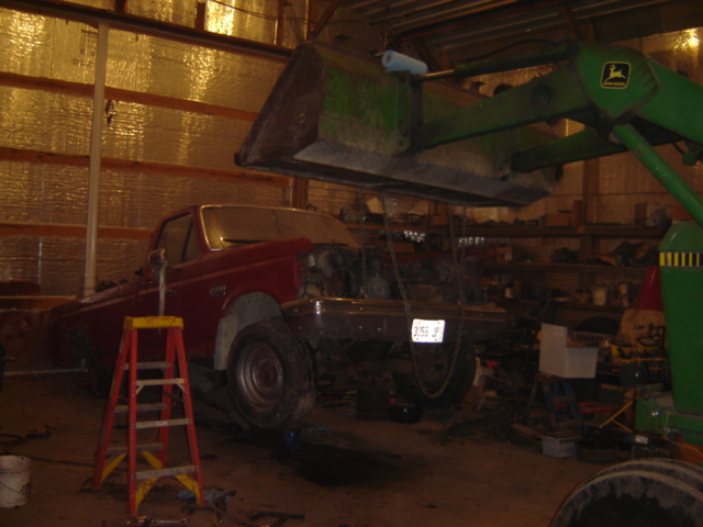Red 1992 Ford Bronco with engine exposed, front view