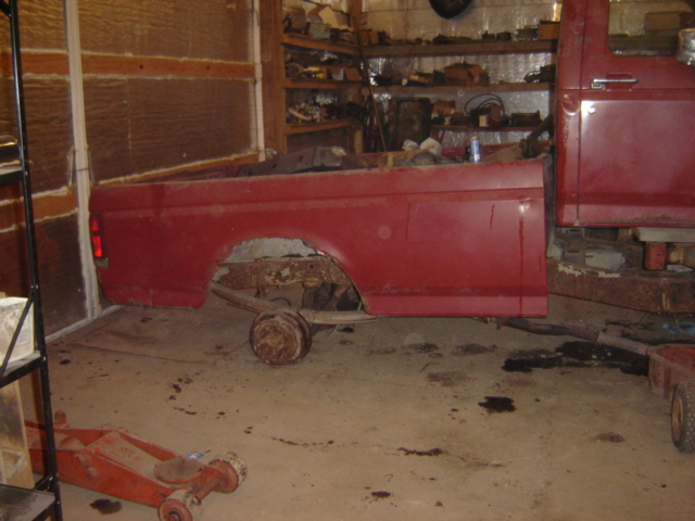 Red 1992 Ford Bronco side view, missing rear axle and wheels