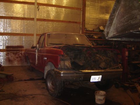 1992 Ford Bronco - This 1992 Ford Bronco pickup truck is in a garage with its hood removed.