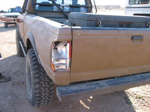 1997 Ford Ranger - Close-up of a damaged taillight on a brown 1997 Ford Ranger pickup truck.